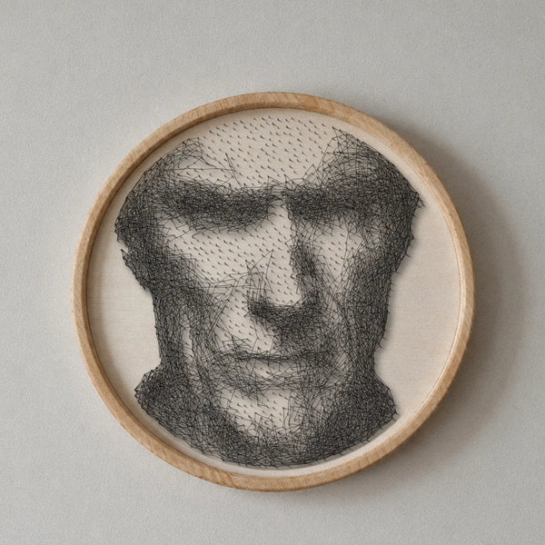 Clint Eastwood string art portrait featuring 1,553 nails and 3,607 thread connections on a 55 cm circular wooden board