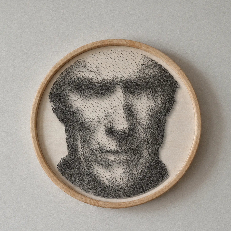 Clint Eastwood string art portrait featuring 1,553 nails and 3,607 thread connections on a 55 cm circular wooden board