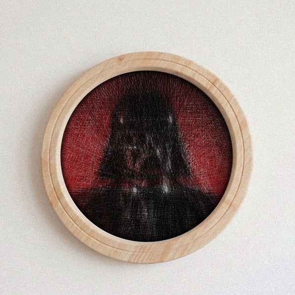 A circular wooden-framed wall string art piece featuring a dark, shadowy Darth Vader-like figure against a red background, mounted on a plain light wall.