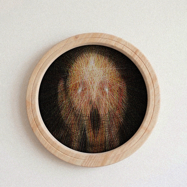 A circular framed string art piece featuring a highly detailed, needlepoint skull design in shades of brown, beige, and black, set within a light natural wood frame against a neutral off-white background.