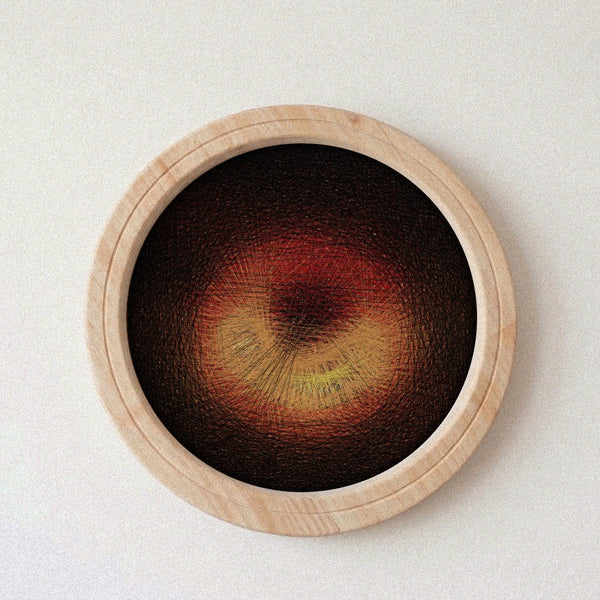 A circular wooden-framed string art piece featuring a textured abstract design in deep brown, red, and yellow tones, mounted on a light off-white textured wall.