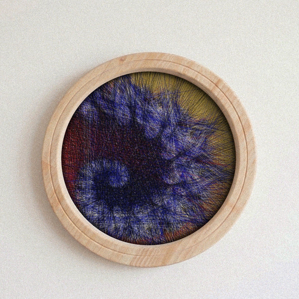 A circular wooden framed abstract string art piece featuring textured, needlepoint-like threads in shades of blue, purple, red, and yellow on a light beige background.